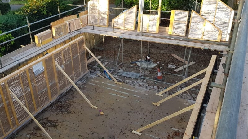 Ground floor external timber frame panels propped, ready for fixing in place